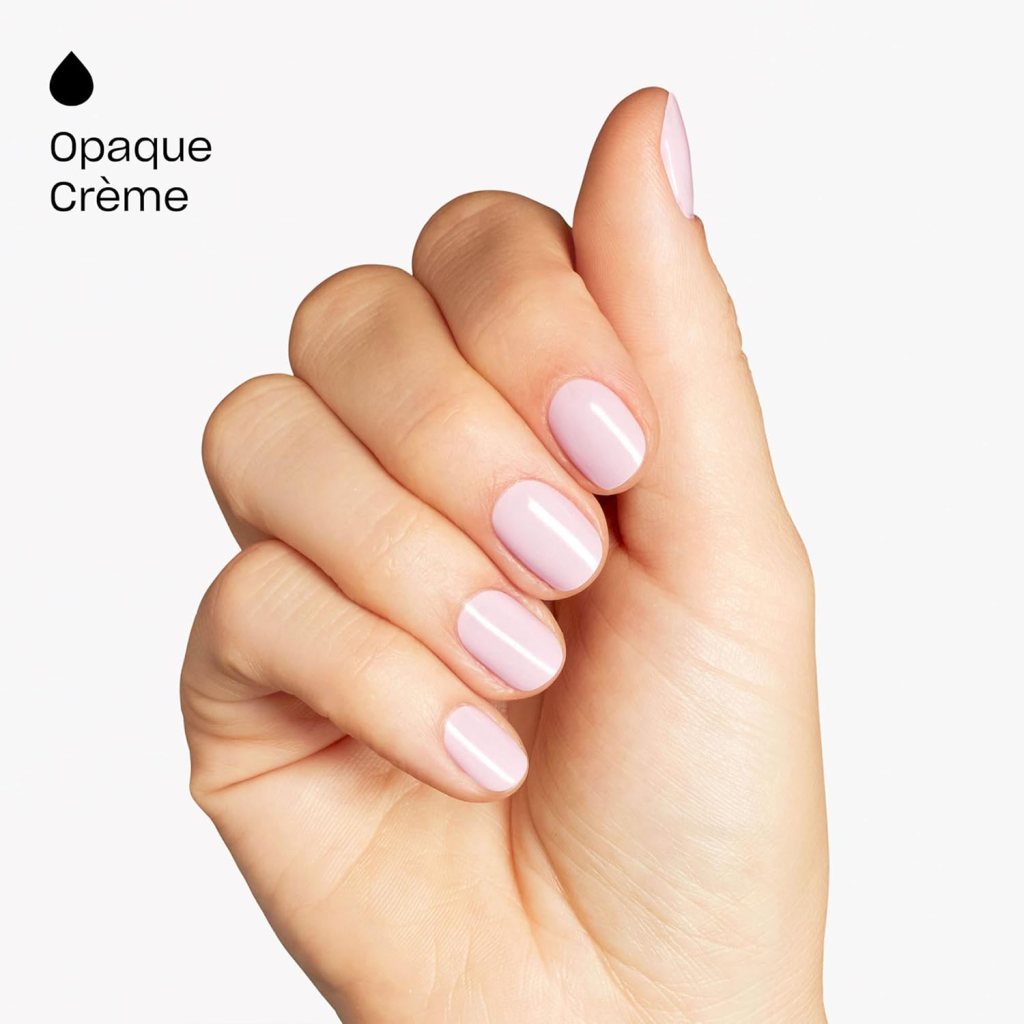 A close-up of a hand displaying neatly manicured nails painted in a light pink opaque crème polish.